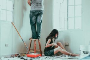 A couple painting a room, renovations